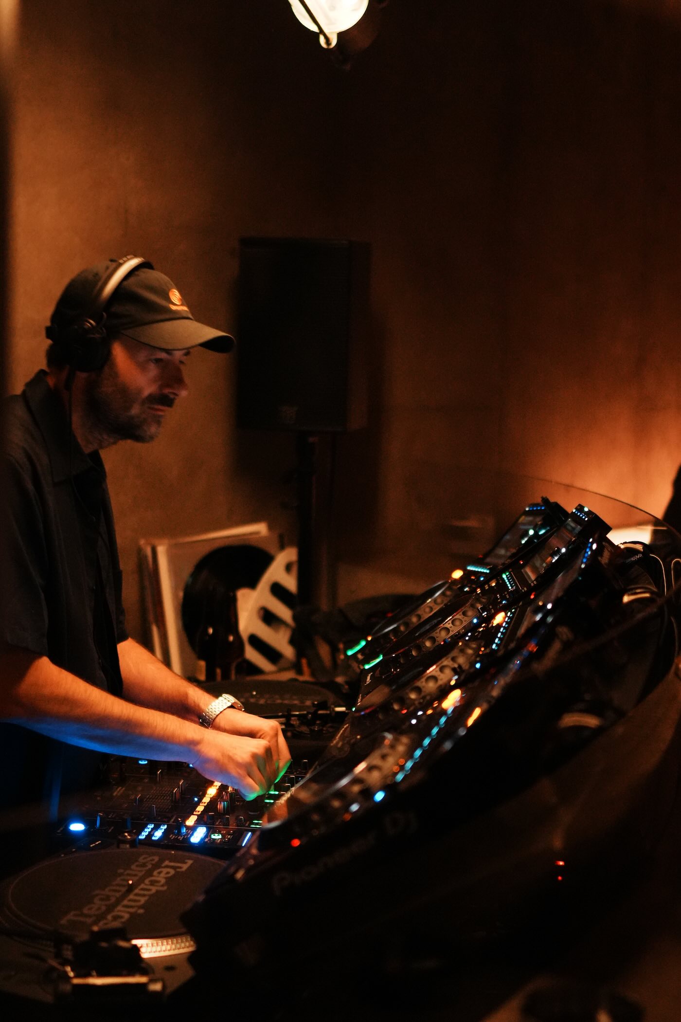 LVCA of Sabotage Milano mixing at a DJ booth, photographed by Raphael Borges.